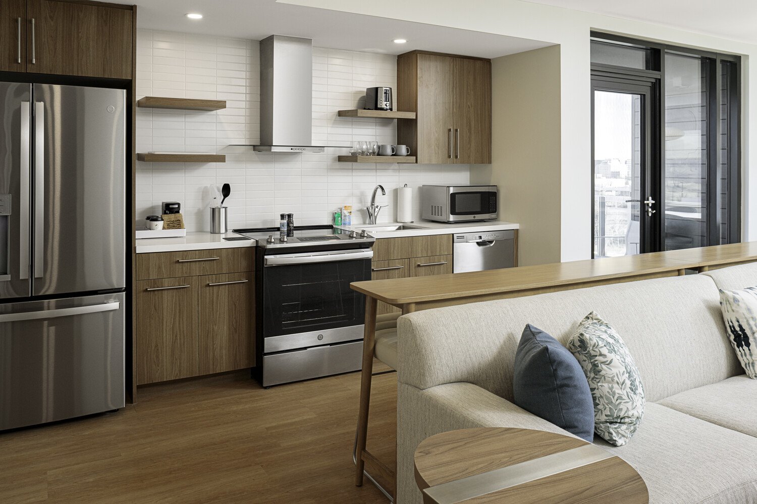 a kitchen and living room with wood cabinets and a couch